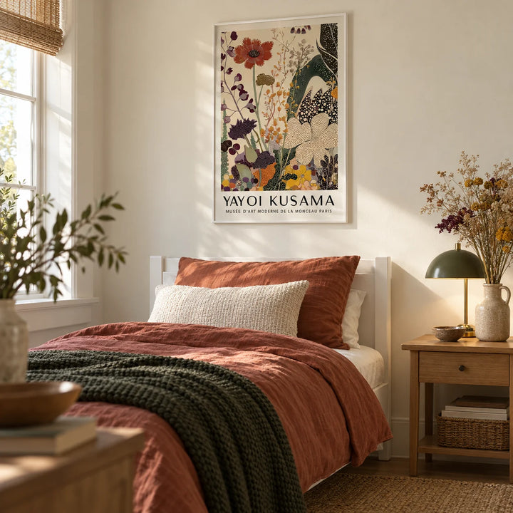 Poster Yayoi Kusama, framed on the wall of a calm single guest bedroom with a soft cream wall