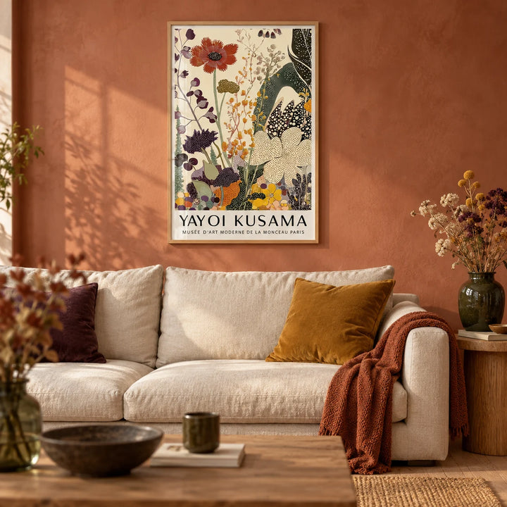 Poster Yayoi Kusama, framed on the wall of a warm living room with a soft rust limewashed wall and a pale oak floor