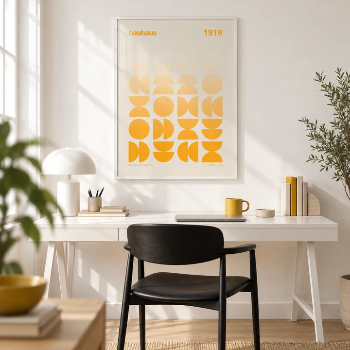 Posters Bauhaus, framed on the wall of a bright design-led home office with a white wall and a pale oak floor