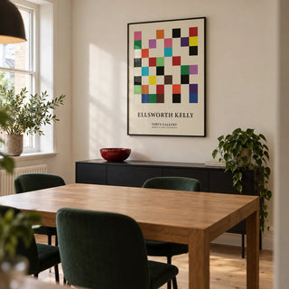 Posters for Office, framed on the wall of a compact modern dining room in a UK terraced house with a warm white wall and pale timber floor