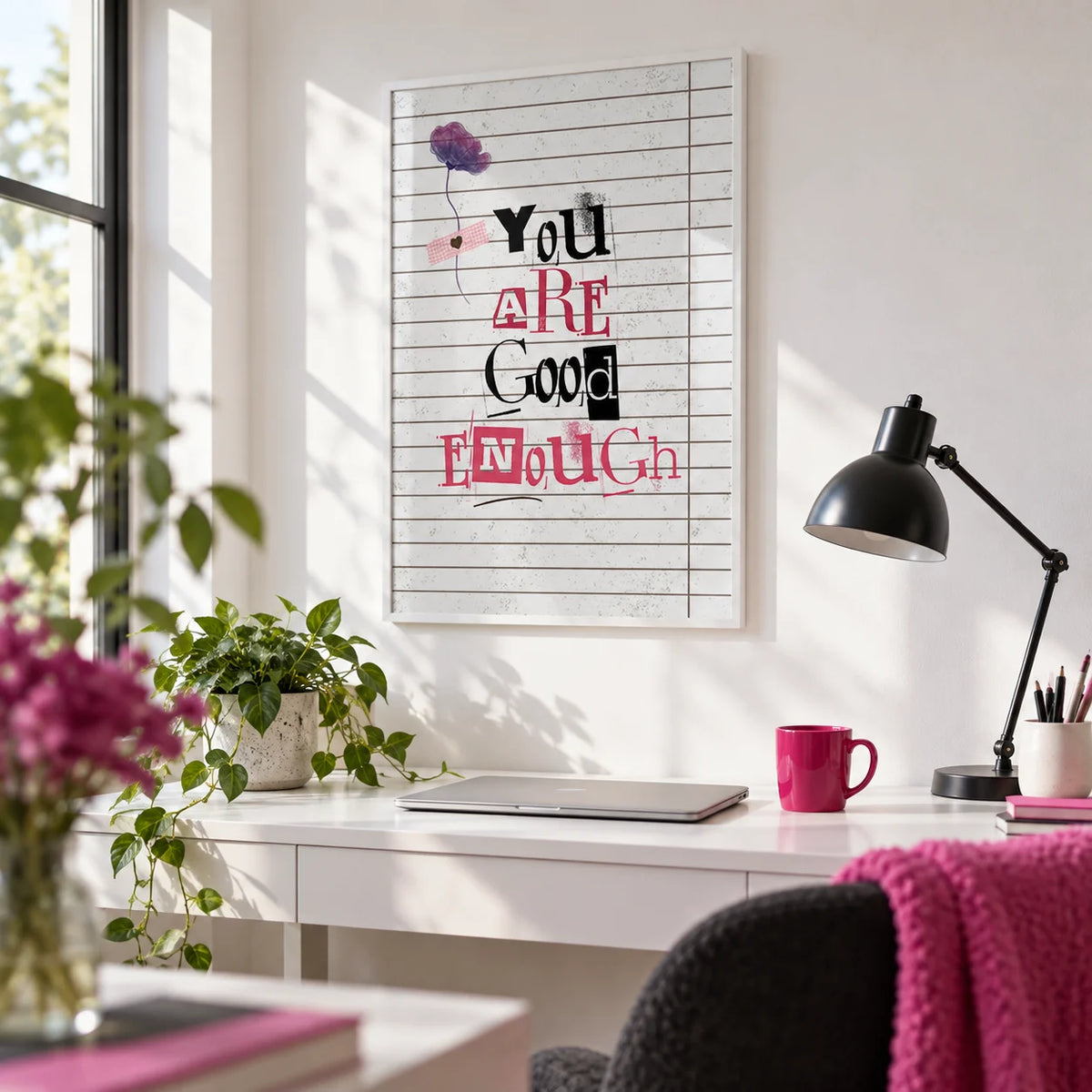 Posters of Positivity, framed on the wall of a bright home office with a white wall