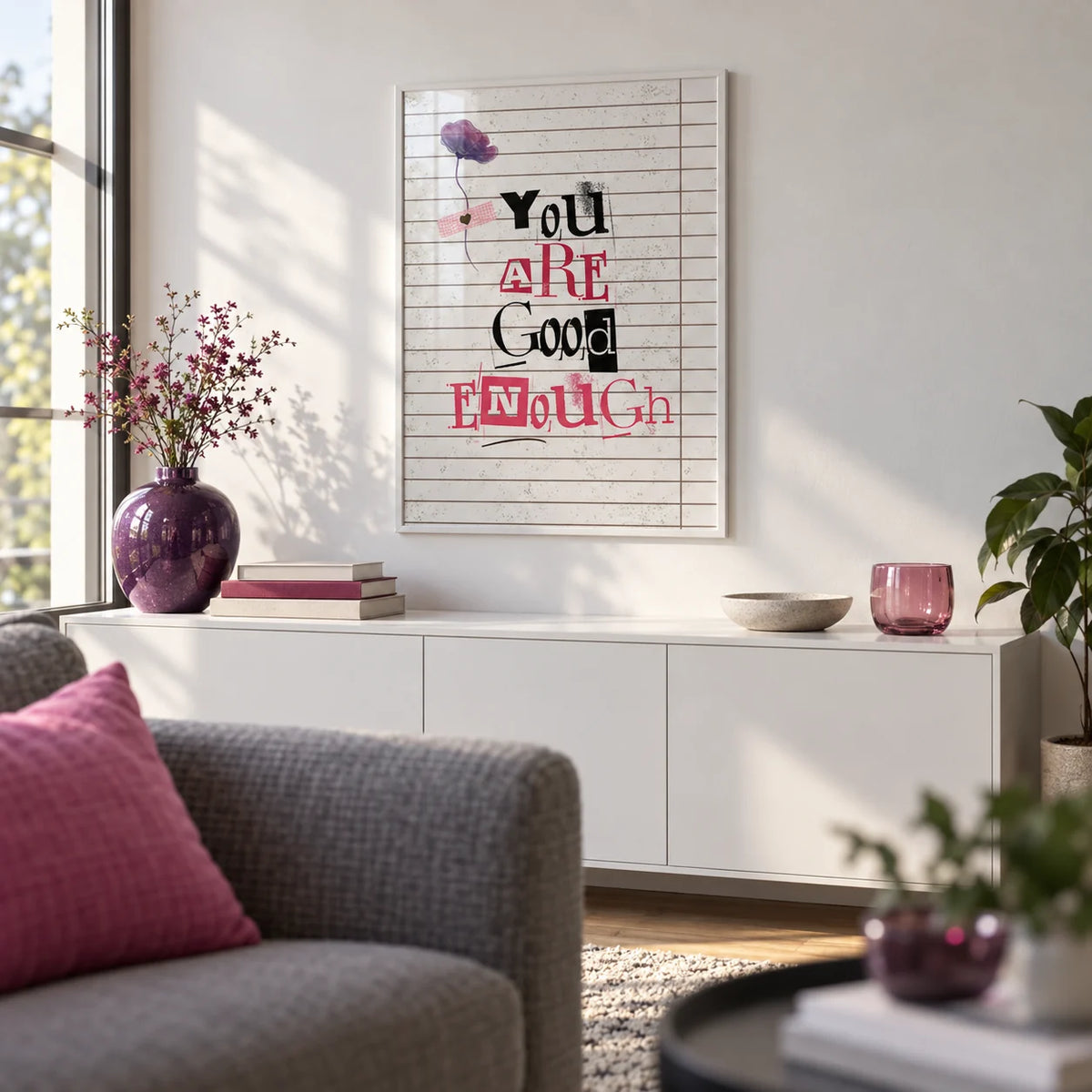 Posters of Positivity, framed on the wall of a first-flat living room (22-28) with a white wall