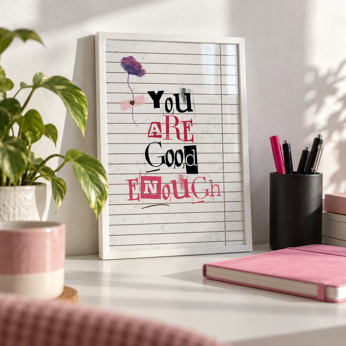 Posters of Positivity, a small A4 framed print leaning on a white desk