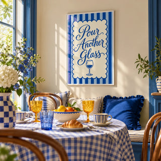 Pour Another Glass Print, framed on the wall of a bright breakfast nook in a kitchen