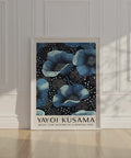 Kusama-inspired blue flowers on a black and white dotted canvas.
