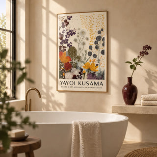 Print Yayoi Kusama, framed on the wall of a calm bathroom with warm cream plaster walls and a freestanding white bath