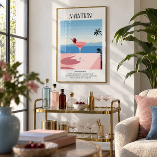 Prints of Cocktails, framed on the wall of a bright living room corner with a white wall