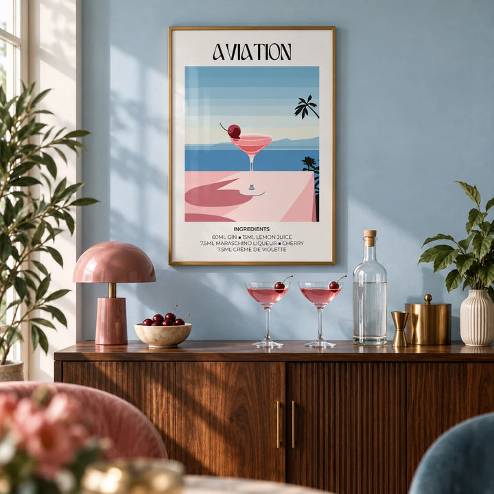Prints of Cocktails, framed on the wall of a stylish home bar corner with a soft sky blue wall in a living room
