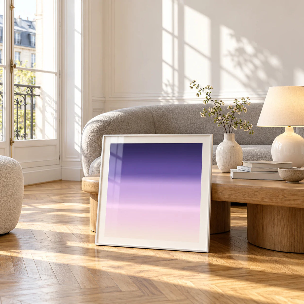 Purple and Pink Wall Art, framed and leaning against a coffee table in a bright living room
