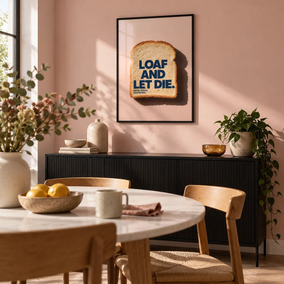 Quirky Kitchen Art, framed on the wall of a modern dining room with a blush pink wall