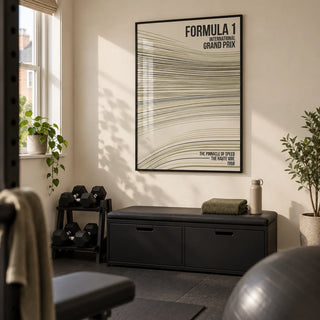 Racing Track Lines Poster, framed on the wall of a compact home gym in a converted UK spare room with a warm cream wall and plain charcoal rubber floor