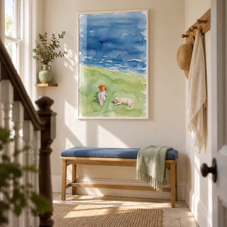 Reading By The Sea Art Print, framed on the wall of a bright narrow hallway in a UK Victorian terrace with cream walls and pale timber flooring