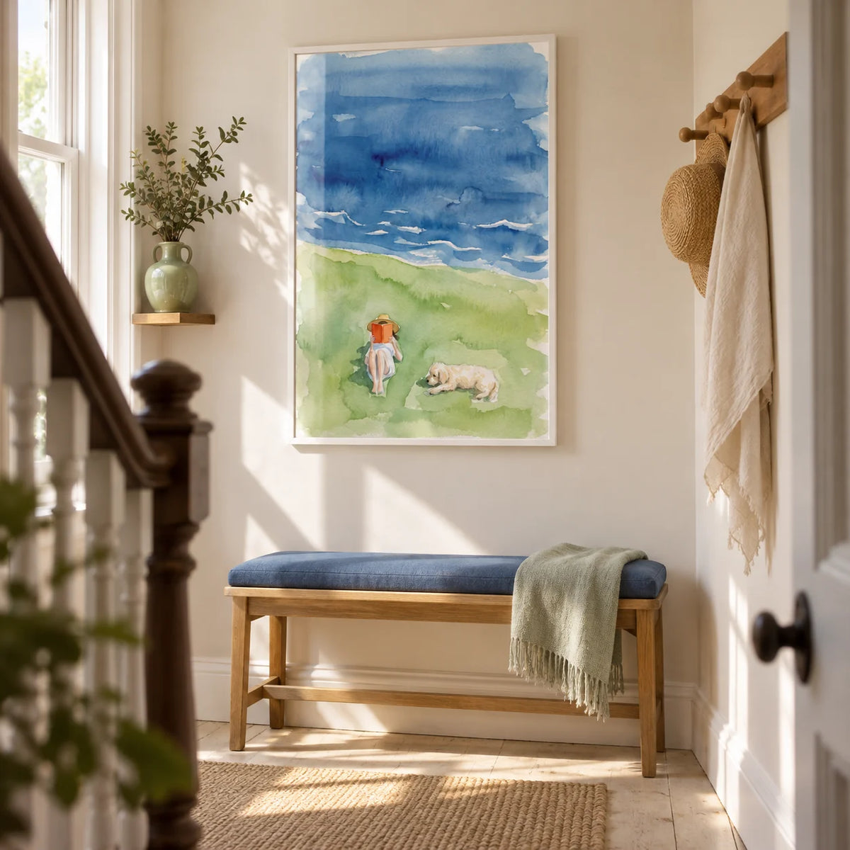 Reading By The Sea Art Print, framed on the wall of a bright narrow hallway in a UK Victorian terrace with cream walls and pale timber flooring