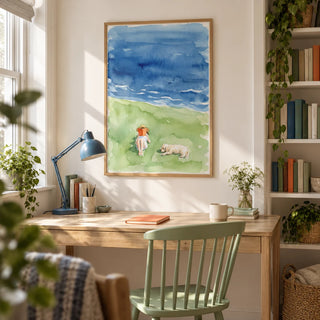 Reading By The Sea Art Print, framed on the wall of a compact study in a UK first flat for a book lover aged 25-35 with a warm white wall and a recessed bookcase