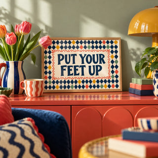 Relaxing Wall Art, a small A4 framed print leaning on a colourful lacquered shelf in a living room