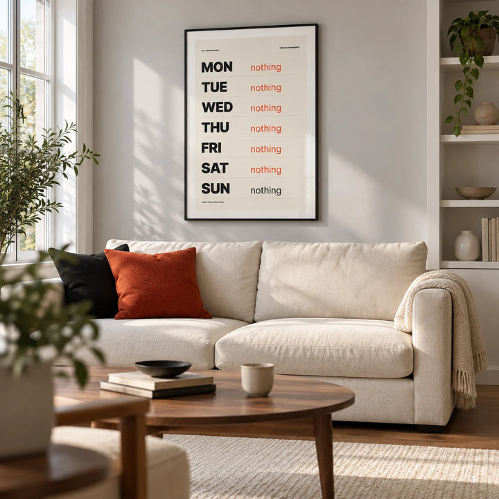 Retirement Plan Print, framed on the wall of a crisp contemporary living room in a downsized UK flat with a pale grey wall