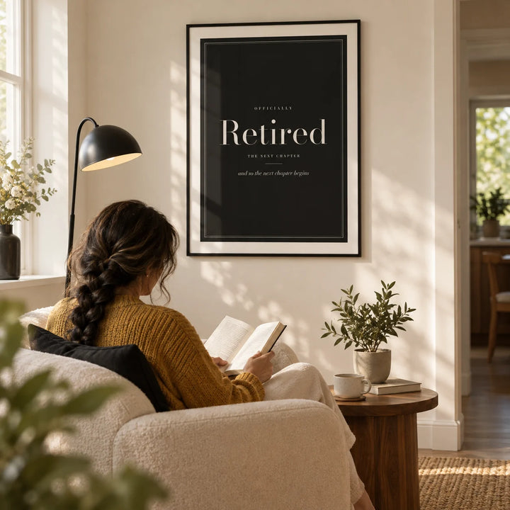 Retirement Poster, framed on the wall of a quiet reading corner in a modern UK bungalow with a warm white wall in a living room