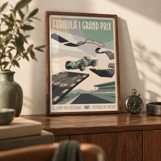 Retro Grand Prix Racing Poster, a small A4 framed print leaning on a walnut sideboard in a living room