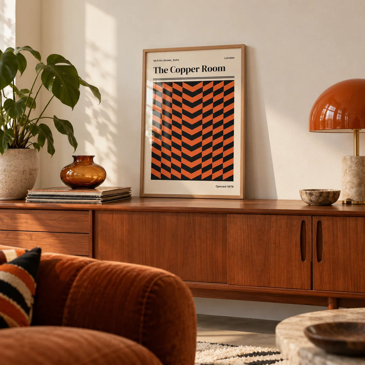 Retro London Poster, a small A4 framed print leaning on a teak sideboard in a living room