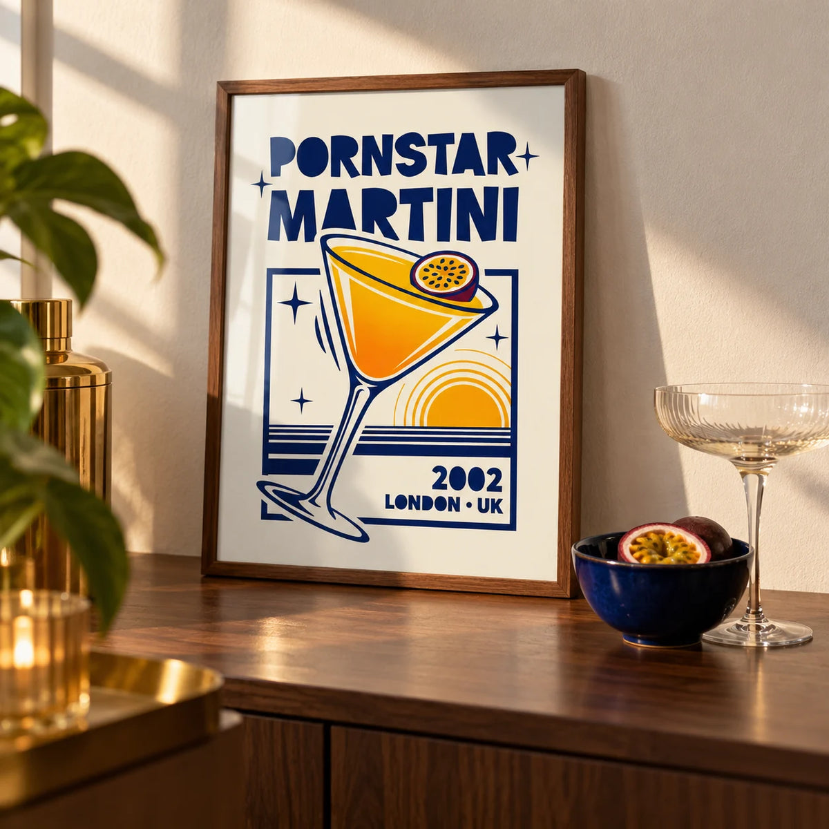 Retro Passion Fruit Martini Poster, a small A4 framed print leaning on a walnut home-bar worktop in a kitchen