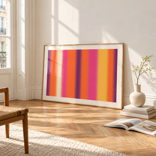 Retro Sunset Print, framed and leaning on the parquet floor of a bright living room