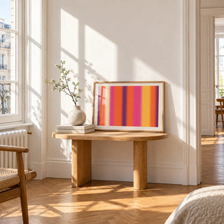 Retro Sunset Print, a small A4 framed print leaning on a small solid oak side table