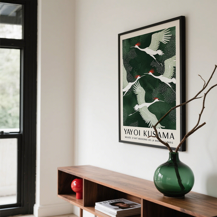 Japandi wall art of red-crowned cranes flying with green and white palette above a wooden shelf