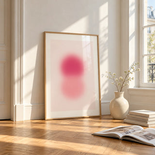 Rose Pink Wall Art, framed and leaning on the parquet floor of a bright living room