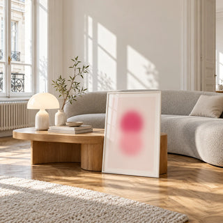 Rose Pink Wall Art, framed and leaning against a coffee table in a bright living room