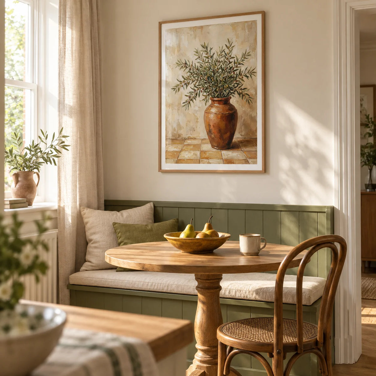 Rustic Olive Art, framed on the wall of a sunlit breakfast nook in a modest UK family home with pale cream walls and a built-in olive green bench in a kitchen