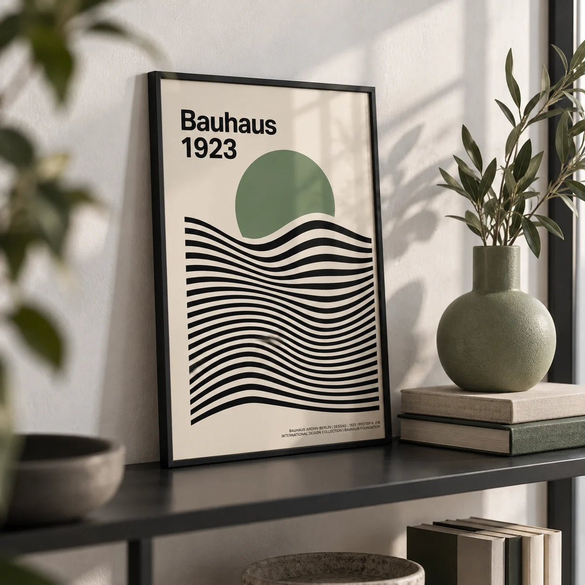 Sage Green Print, a small A4 framed print leaning on a black metal shelf in a living room
