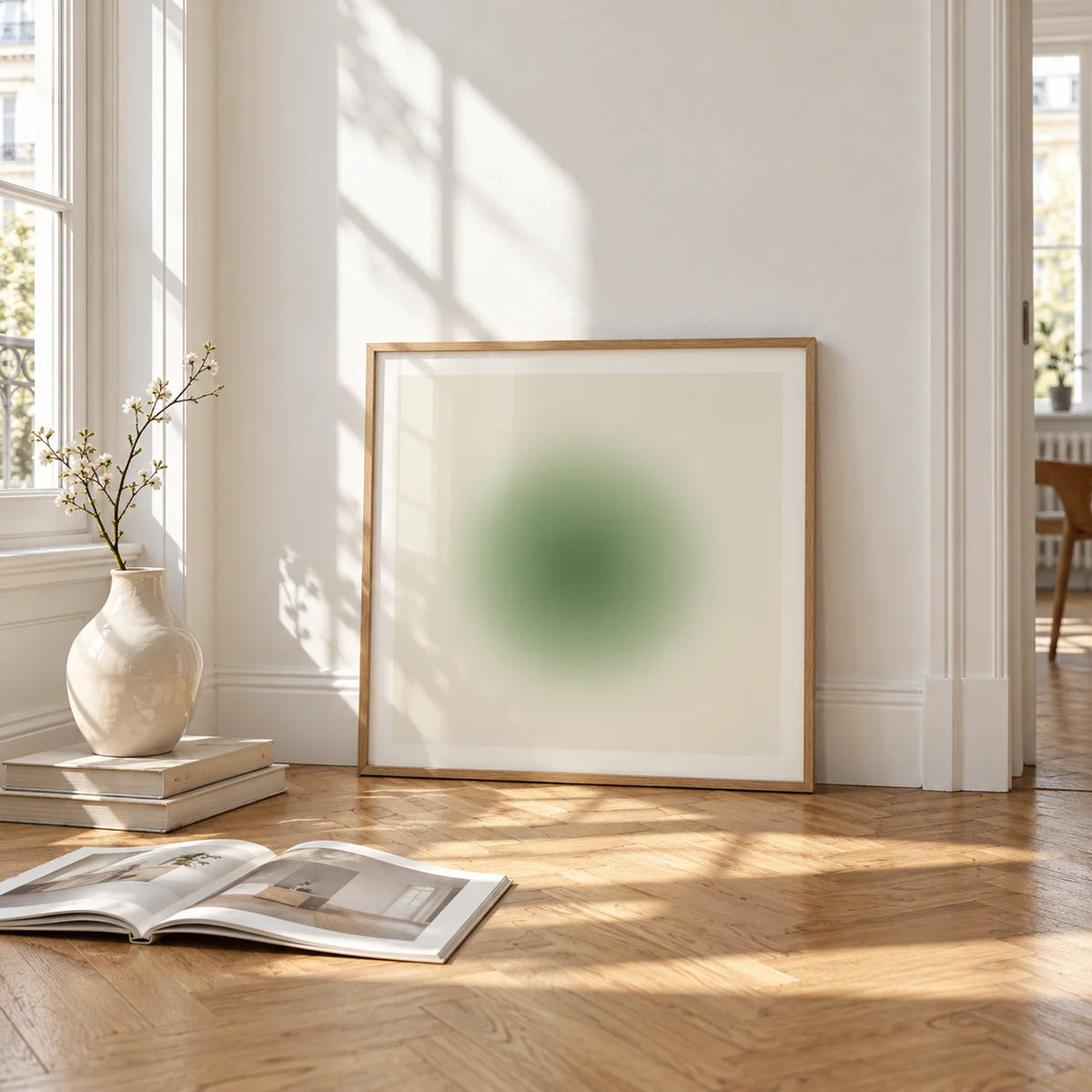 Sage Wall Art, framed and leaning on the parquet floor of a bright living room