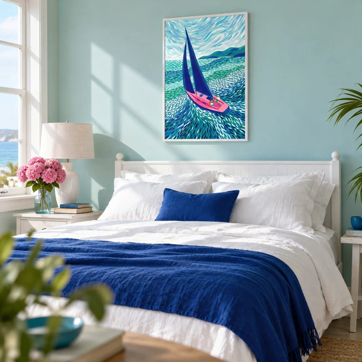 Sailboat Art Print, framed on the wall of a seaside bedroom with a pale turquoise wall