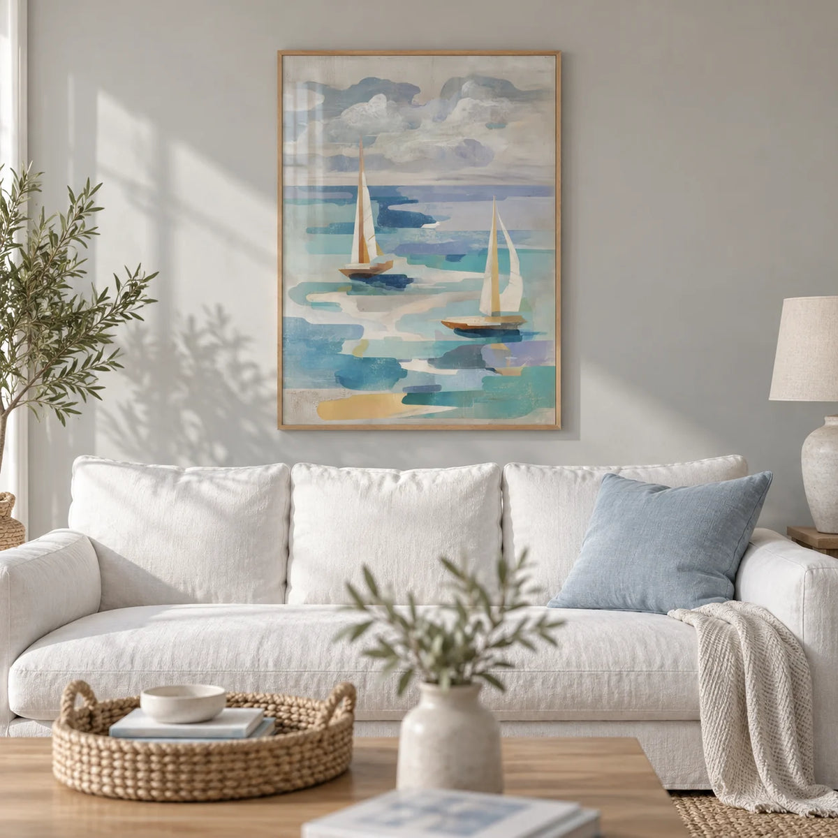 Sailboat Water Art, framed on the wall of a calm coastal living room with a soft grey wall