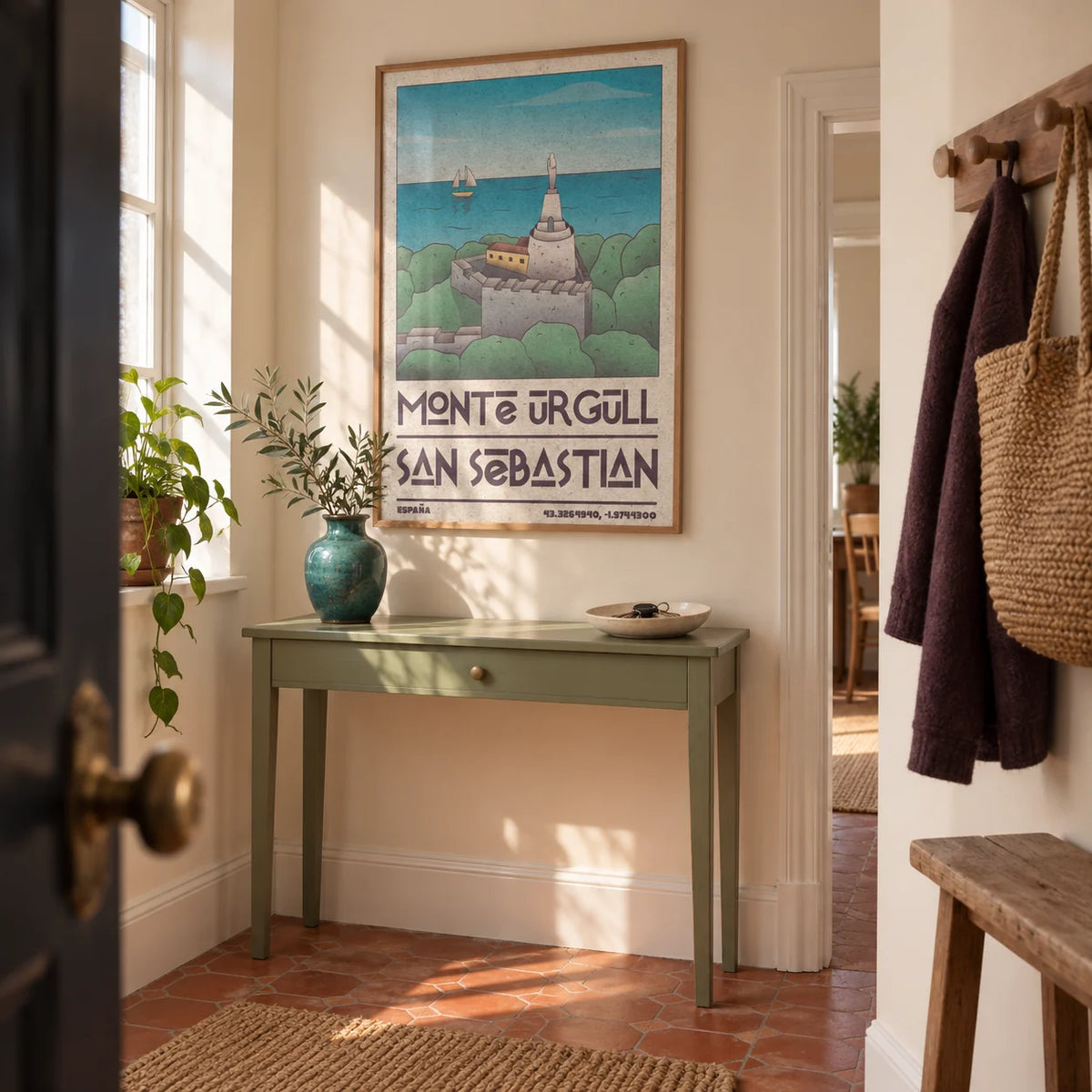 San Sebastian Art Print, framed on the wall of a welcoming hallway in a UK period flat with pale cream walls and a terracotta floor