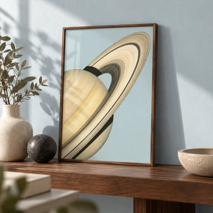 Saturn Wall Art, a small A4 framed print leaning on a walnut shelf in a living room