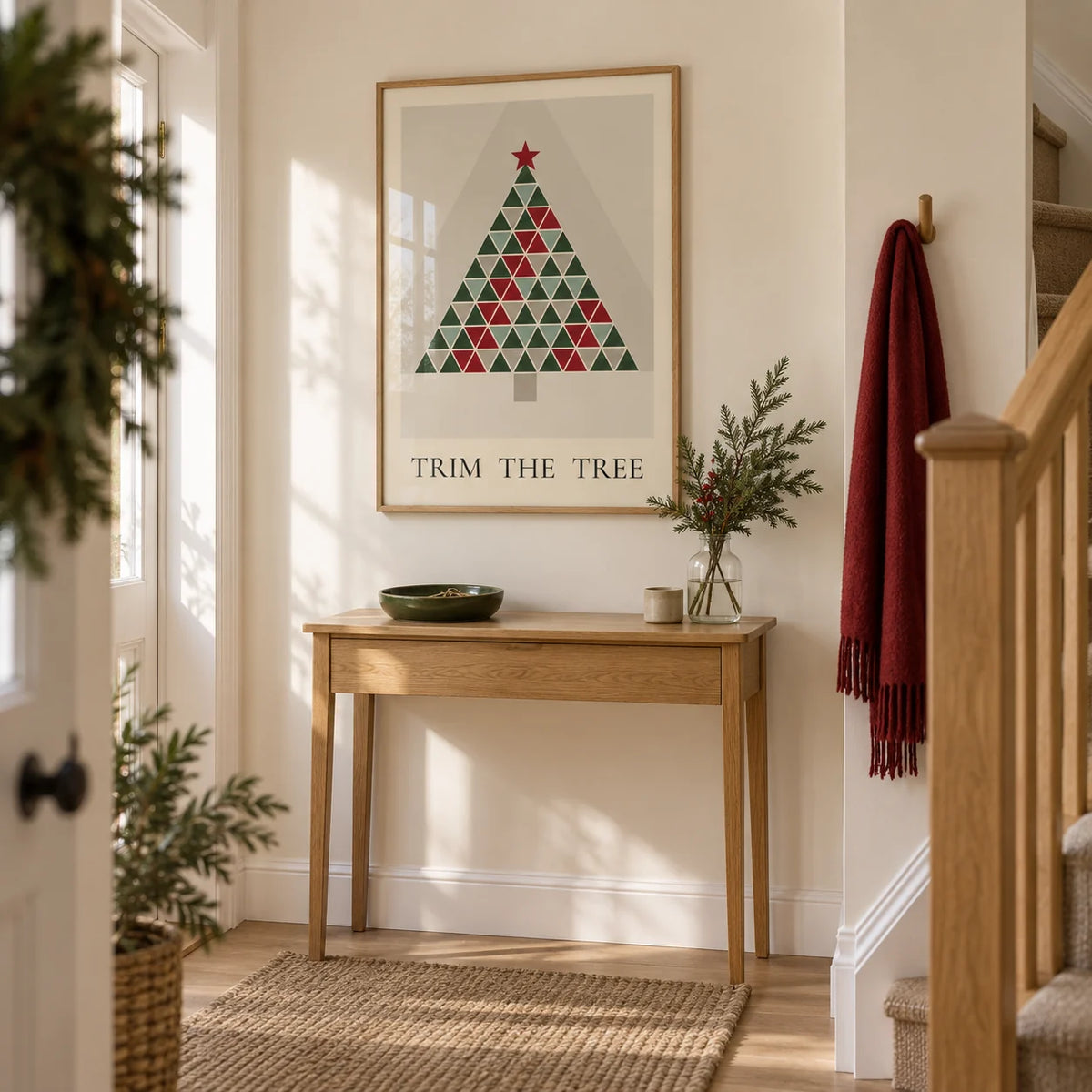 Scandinavian Christmas Print, framed on the wall of a bright entrance hallway in a UK family home with cream walls and a simple oak staircase