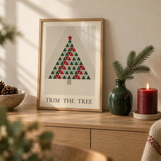 Scandinavian Christmas Print, a small A4 framed print leaning on a pale oak sideboard in a living room