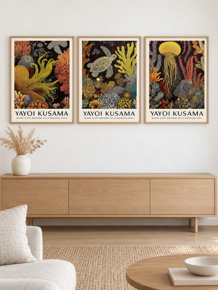 Sea Life Prints Set of 3 hung at eye level above a light oak sideboard: Golden Tentacle, Turtle Drift and Luminous Drift shown framed side by side (frames not included)