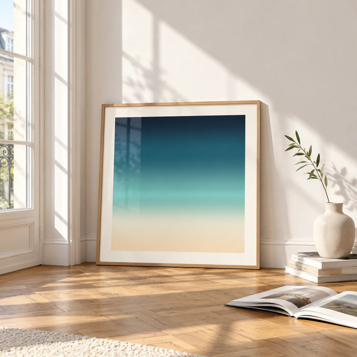 Sea Print, framed and leaning on the parquet floor of a bright living room