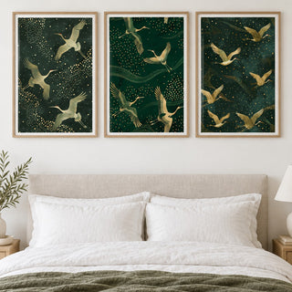 Set of 3 Art Prints hung at eye level above a bed in a calm bedroom: Crane Trio, Flight of Cranes and Soaring Elegance shown framed side by side (frames not included)