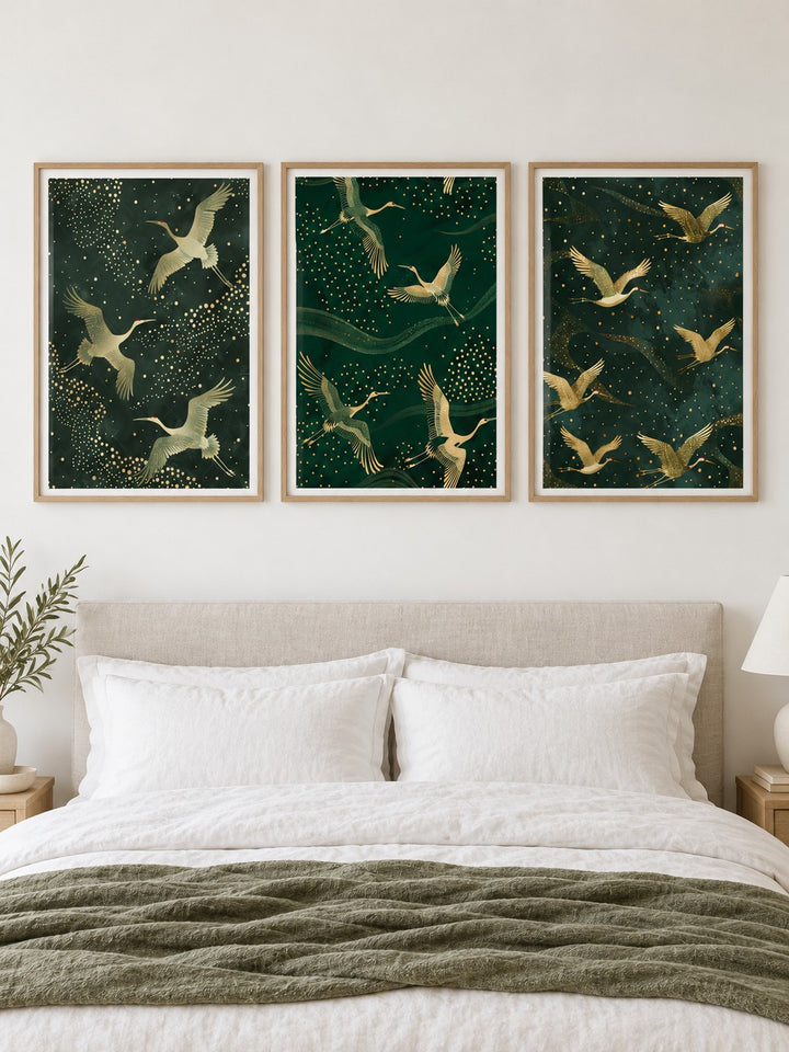 Set of 3 Art Prints hung at eye level above a bed in a calm bedroom: Crane Trio, Flight of Cranes and Soaring Elegance shown framed side by side (frames not included)
