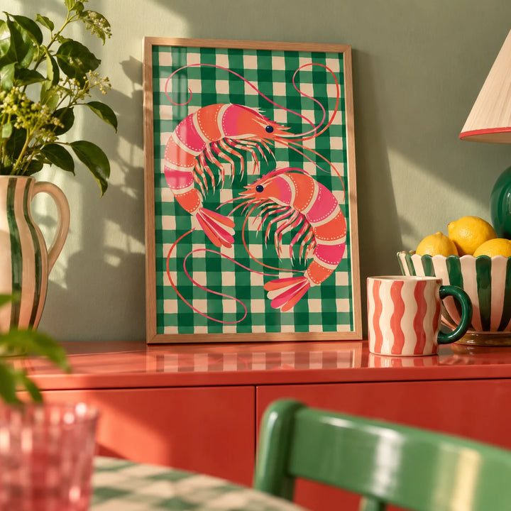 Shrimp Poster, a small A4 framed print leaning on a colourful lacquered shelf in a living room