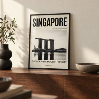 Singapore Modern Architecture Art Print, a small A4 framed print leaning on a walnut side table in a hallway