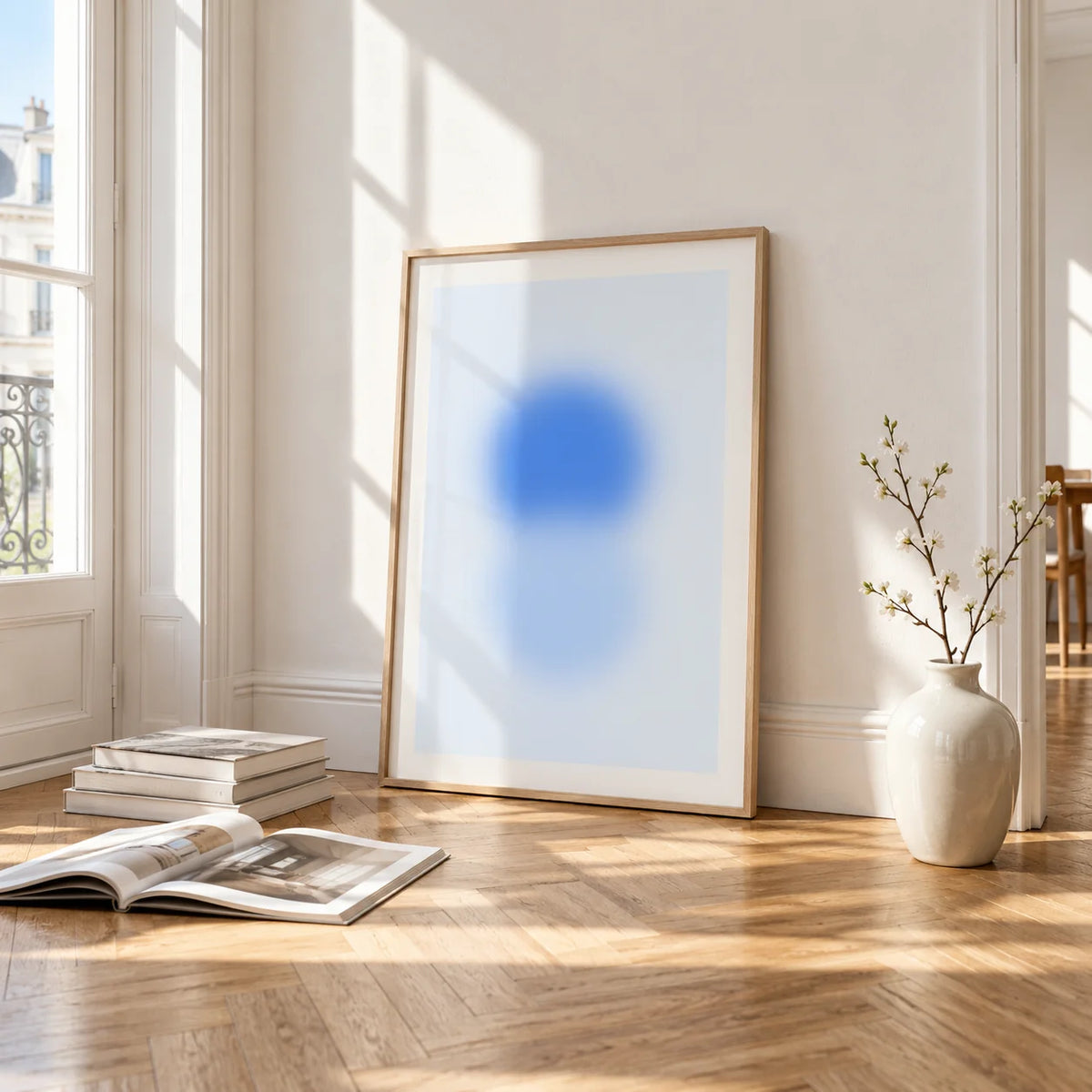 Sky Blue Print, framed and leaning on the parquet floor of a bright living room