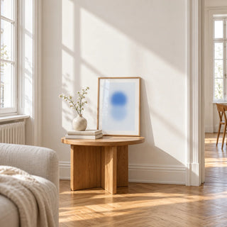 Sky Blue Print, a small A4 framed print leaning on a small solid oak side table