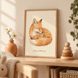 Sleepy Fox Art Print, a small A4 framed print leaning on a pale oak nursery shelf