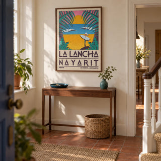 Surfer Beach Art Print, framed on the wall of a welcoming hallway in a British terraced house with cream walls and terracotta floor tiles
