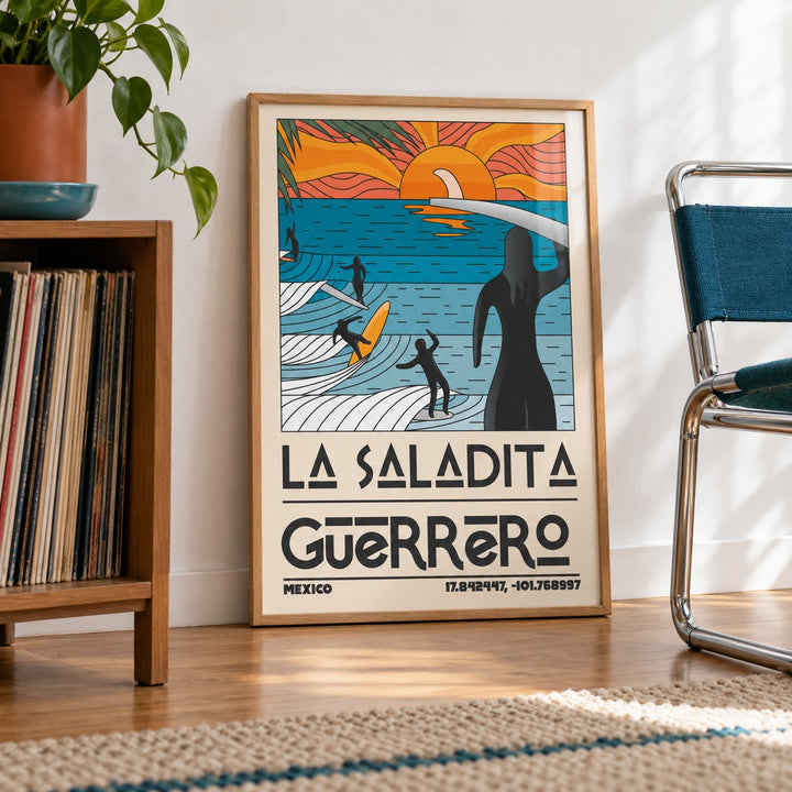 Surfing Sunset Print shown in a living room, leaning on the floor by a chrome chair (frame not included)
