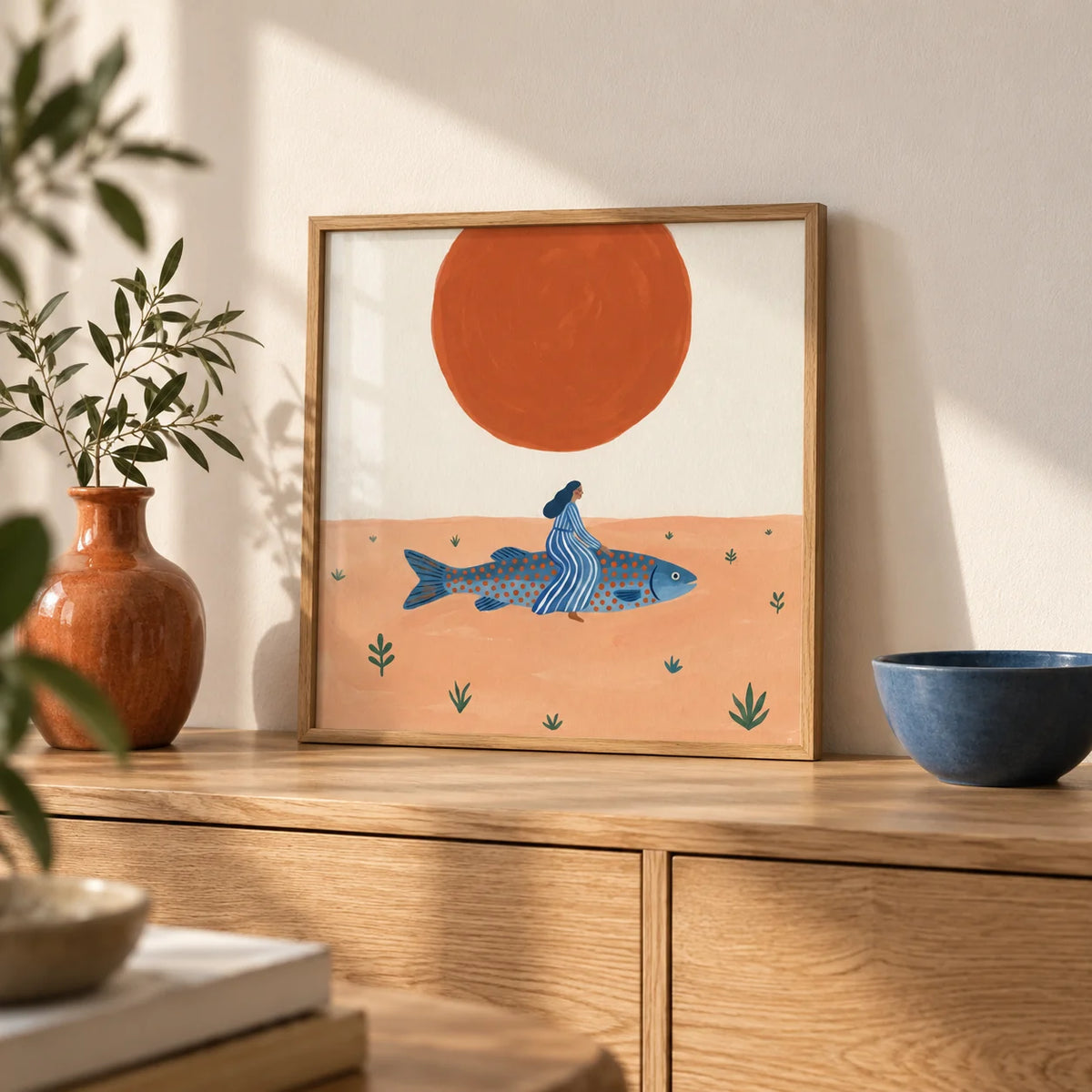 Surreal Fish Art Print, a small A4 framed print leaning on a pale oak sideboard in a living room